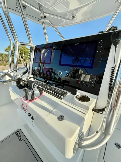  Yacht Photos Pics Control panel of 2023 Freeman 34VH boat with steering wheel and navigation screens.