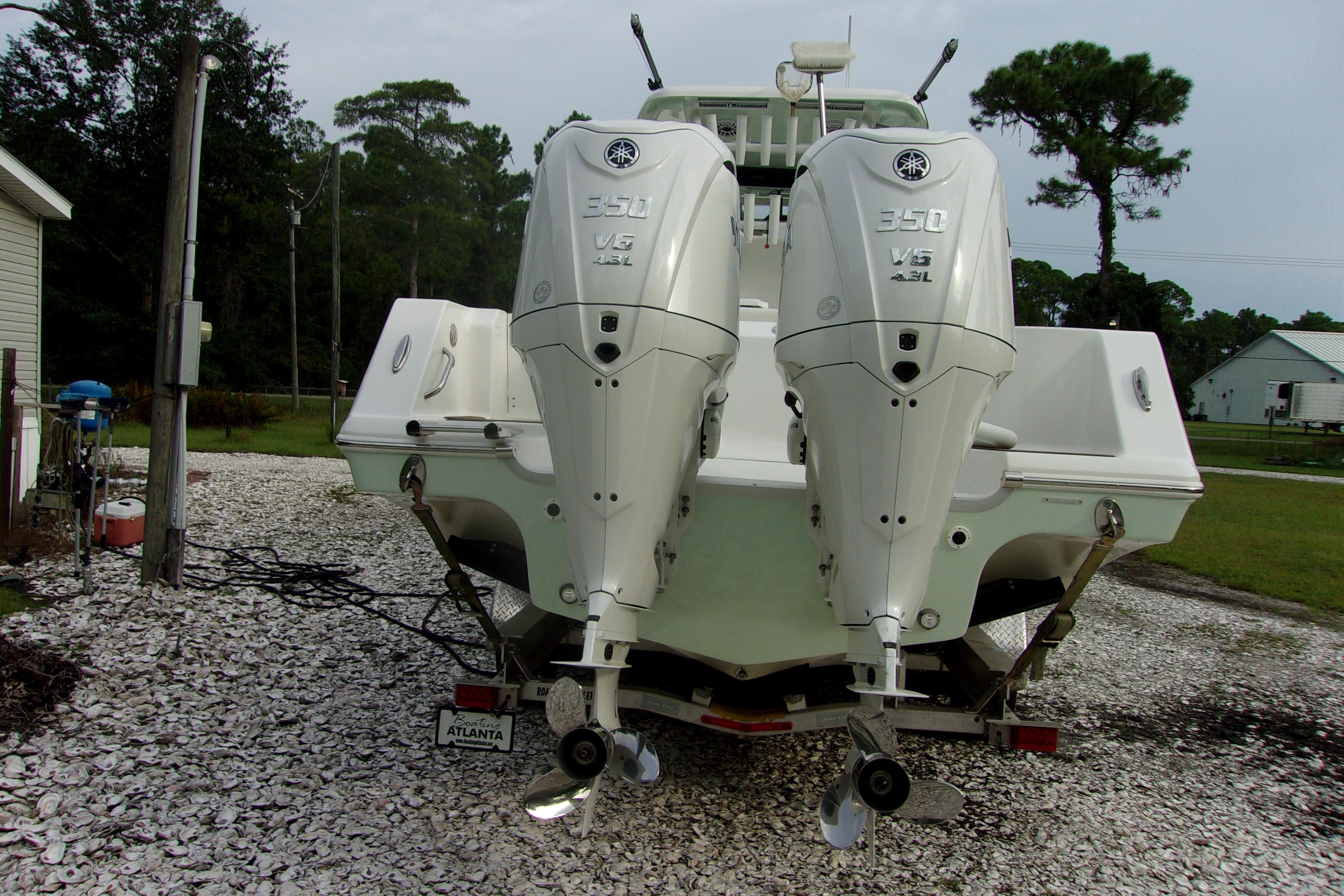 2025 Tidewater 320 CC Adventure boat with dual Yamaha 350 engines, parked outdoors.