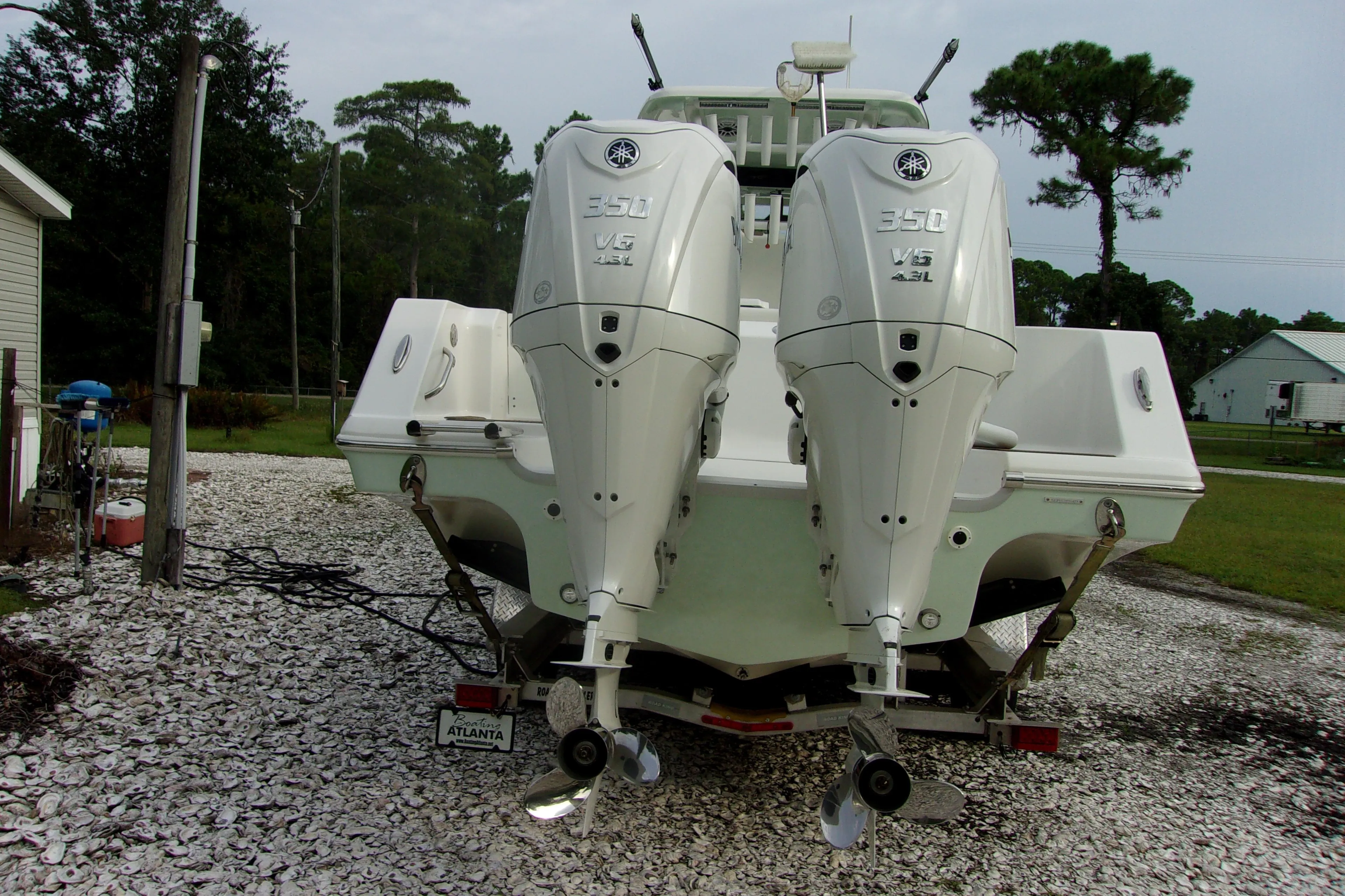 2025 Tidewater 320 CC Adventure boat with dual Yamaha 350 engines, parked outdoors.