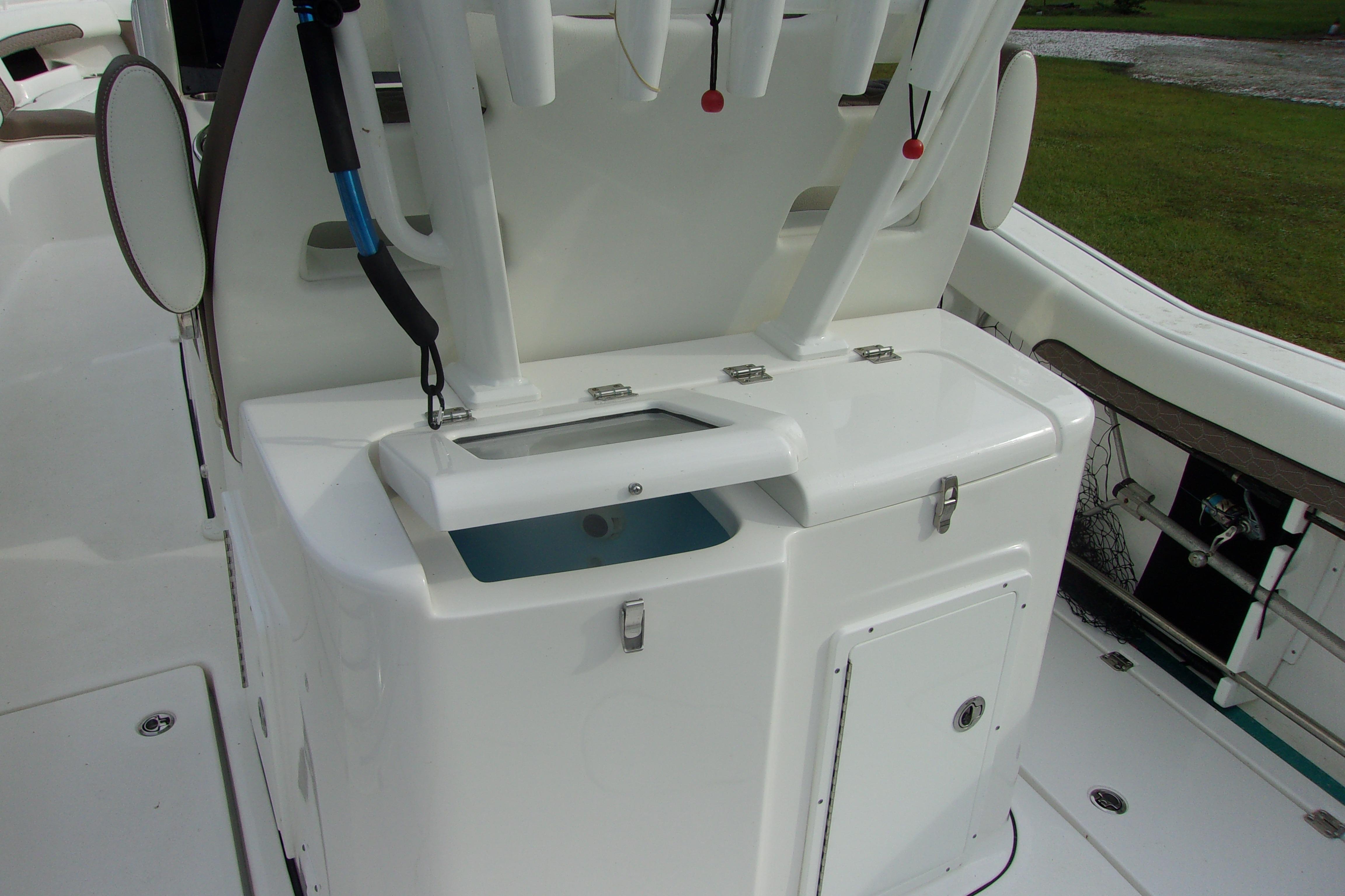 2025 Tidewater 320 CC Adventure boat interior with storage compartments and fishing rod holders.