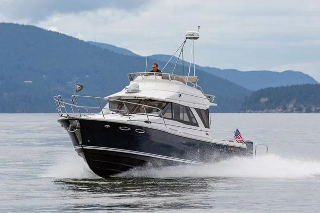  Yacht Photos Pics Manufacturer Provided Image: 2021 Cutwater C-32 CB cruising on a lake with mountains in the background.