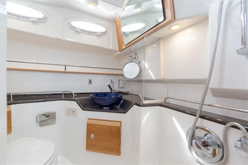  Yacht Photos Pics Manufacturer Provided Image: 2022 Cutwater C-32 CB boat bathroom with modern fixtures and blue sink.