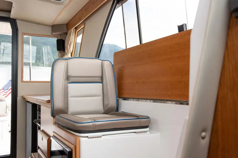  Yacht Photos Pics Manufacturer Provided Image: 2022 Cutwater C-32 CB interior helm seat with modern design and panoramic windows.
