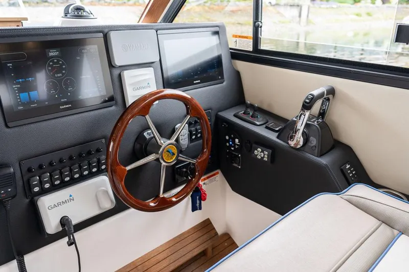  Yacht Photos Pics Manufacturer Provided Image: 2022 Cutwater C-32 CB helm with Garmin navigation system and wooden steering wheel.