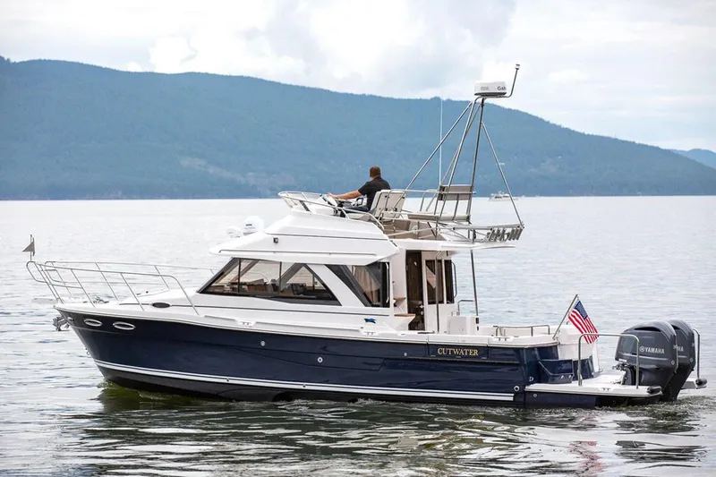  Yacht Photos Pics Manufacturer Provided Image: 2021 Cutwater C-32 CB boat cruising on a lake with mountains in the background.