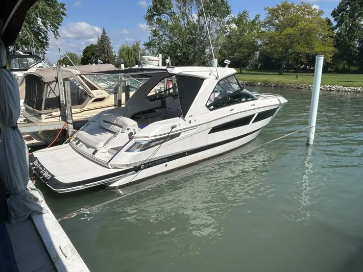  Yacht Photos Pics 2017 Four Winns H350 boat docked on calm water under a clear sky.