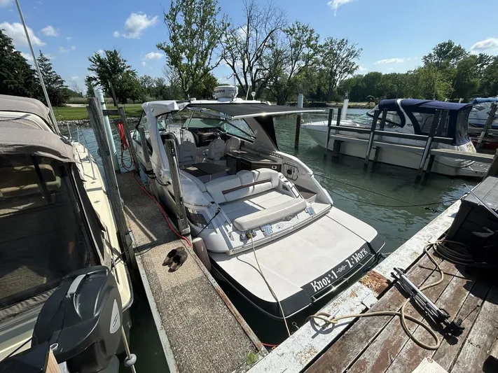  Yacht Photos Pics 2017 Four Winns H350 boat docked at marina, surrounded by other boats, under clear blue sky.