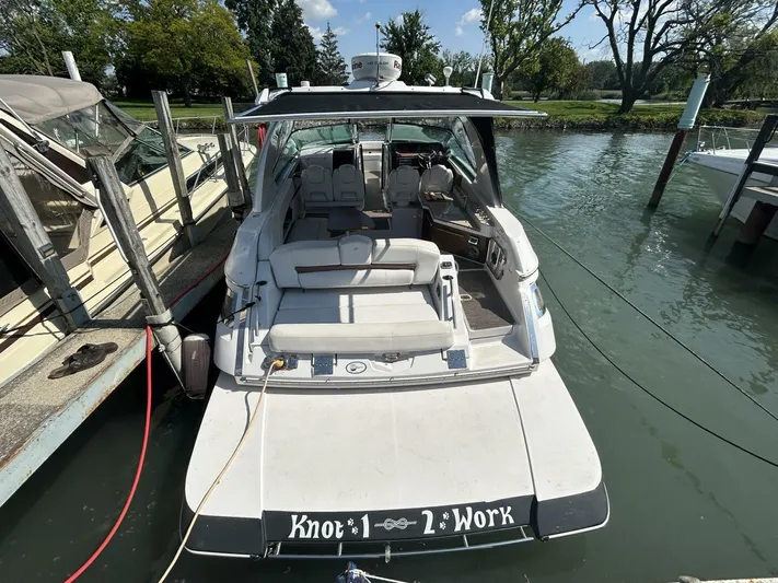 Yacht Photos Pics 2017 Four Winns H350 boat docked, rear view, with "Knot 2 Work" on the stern.