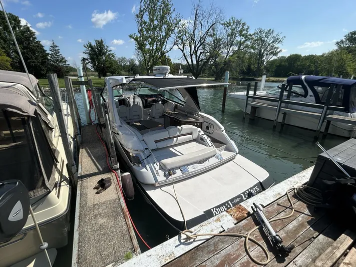  Yacht Photos Pics 2017 Four Winns H350 boat docked at a marina on a sunny day.