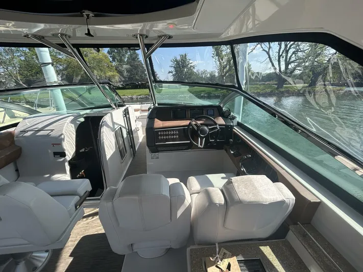  Yacht Photos Pics Interior view of 2017 Four Winns H350 boat cockpit with plush seating and steering console.