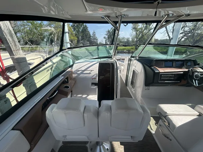  Yacht Photos Pics 2017 Four Winns H350 boat interior with dual white seats and modern dashboard.