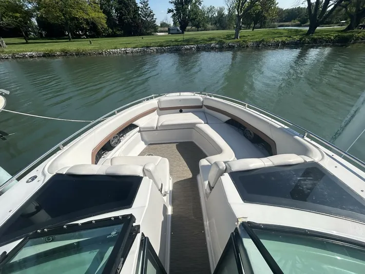  Yacht Photos Pics 2017 Four Winns H350 boat with spacious seating, docked on a calm lake.