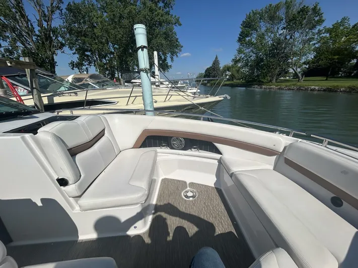  Yacht Photos Pics 2017 Four Winns H350 boat interior with white seating, docked by a scenic waterway.