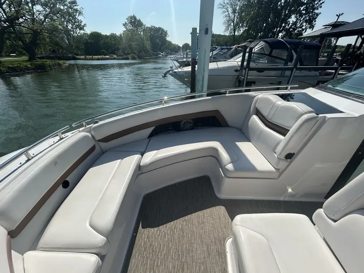  Yacht Photos Pics 2017 Four Winns H350 boat with spacious seating, docked by a serene river.