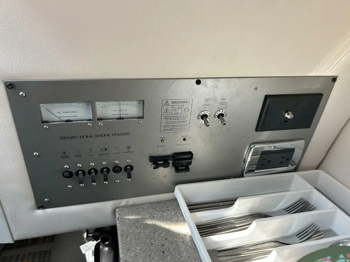  Yacht Photos Pics Control panel of a 2017 Four Winns H350 boat with electrical switches and utensil tray.
