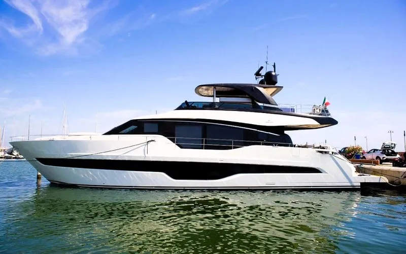  Yacht Photos Pics 2022 Cranchi Settantotto 78 yacht docked in a marina under a clear blue sky.