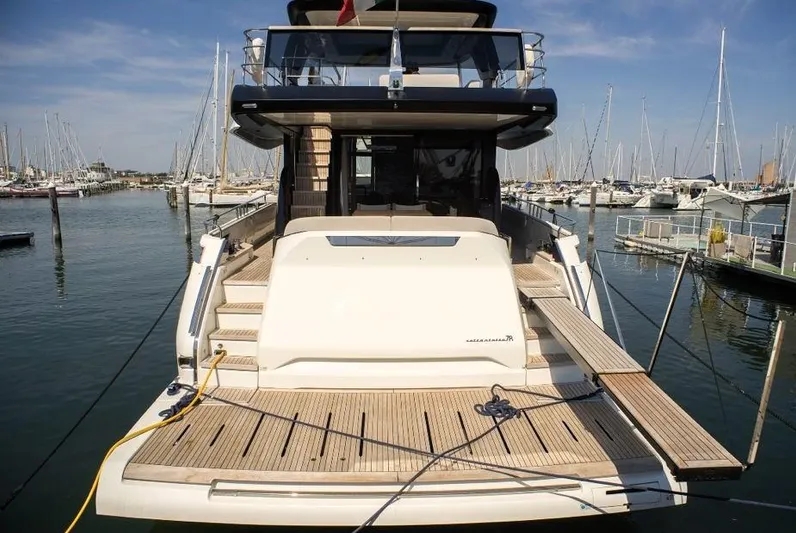  Yacht Photos Pics 2022 Cranchi Settantotto 78 yacht docked at marina, rear view with wooden deck.