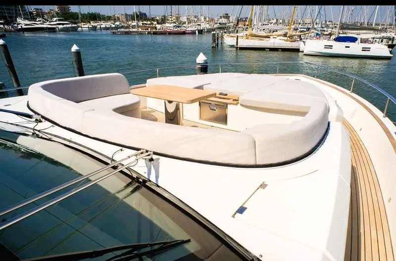  Yacht Photos Pics Luxurious 2022 Cranchi Settantotto 78 yacht with elegant deck seating and scenic marina view.