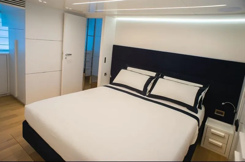  Yacht Photos Pics Luxurious bedroom interior on 2022 Cranchi Settantotto 78 yacht, featuring modern design and elegant bedding.