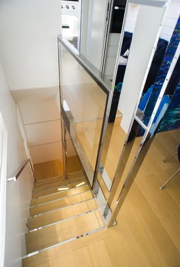  Yacht Photos Pics Modern staircase with glass and metal railing on Cranchi Settantotto 78 yacht, 2022 model.