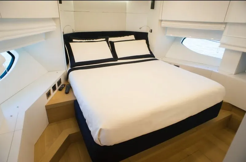  Yacht Photos Pics Luxurious bedroom interior of 2022 Cranchi Settantotto 78 yacht with modern design and cozy bedding.