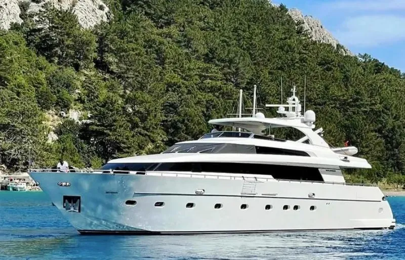  Yacht Photos Pics 2009 Sanlorenzo SL88 yacht cruising near a lush, forested coastline.