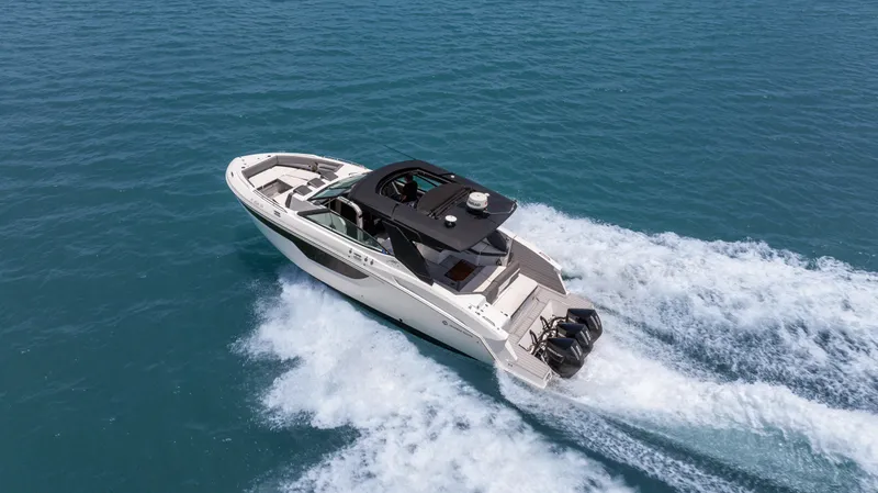  Yacht Photos Pics 2020 Cruisers Yachts 38 GLS OB speeding on open water, aerial view.