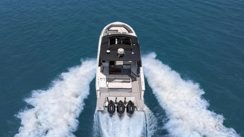  Yacht Photos Pics 2020 Cruisers Yachts 38 GLS OB speeding on open water, aerial view.