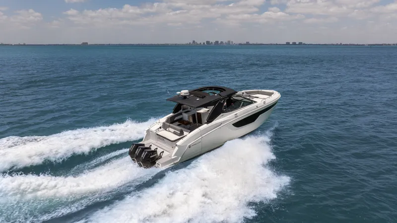  Yacht Photos Pics 2020 Cruisers Yachts 38 GLS OB speeding on open water under a clear sky.