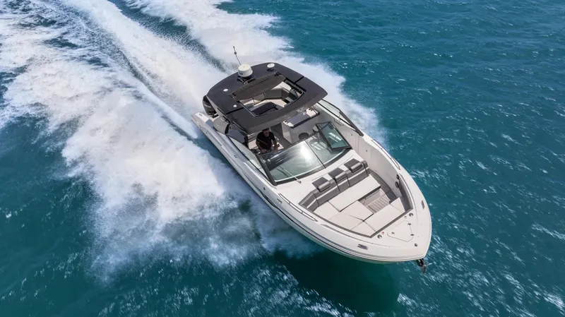  Yacht Photos Pics 2020 Cruisers Yachts 38 GLS OB speeding on blue ocean waters.