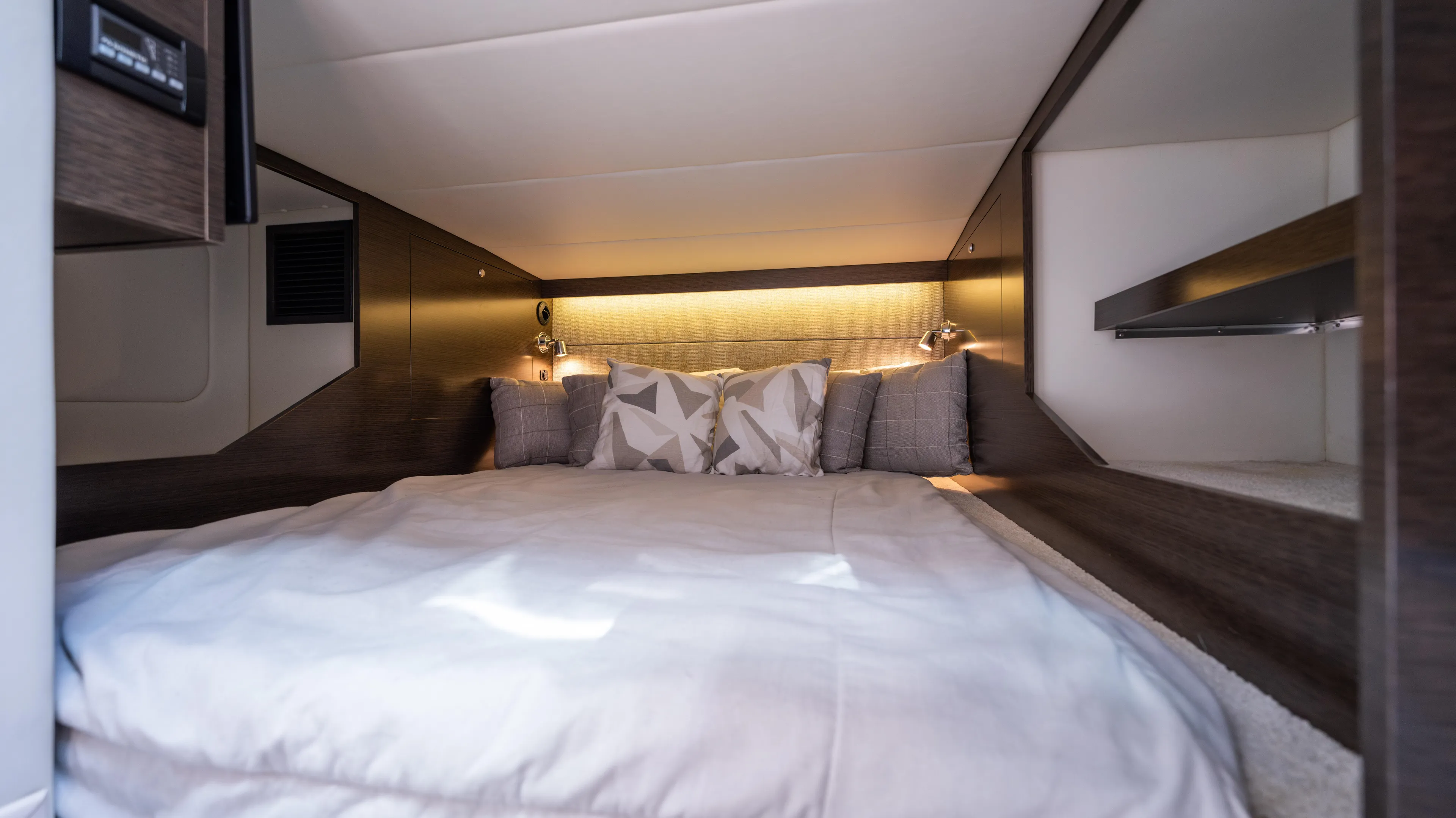  Yacht Photos Pics Luxurious cabin interior of 2020 Cruisers Yachts 38 GLS OB with cozy bedding and ambient lighting.