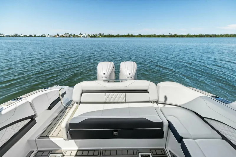  Yacht Photos Pics 2022 Regal 33 OBX boat interior with luxurious seating, overlooking calm blue waters.