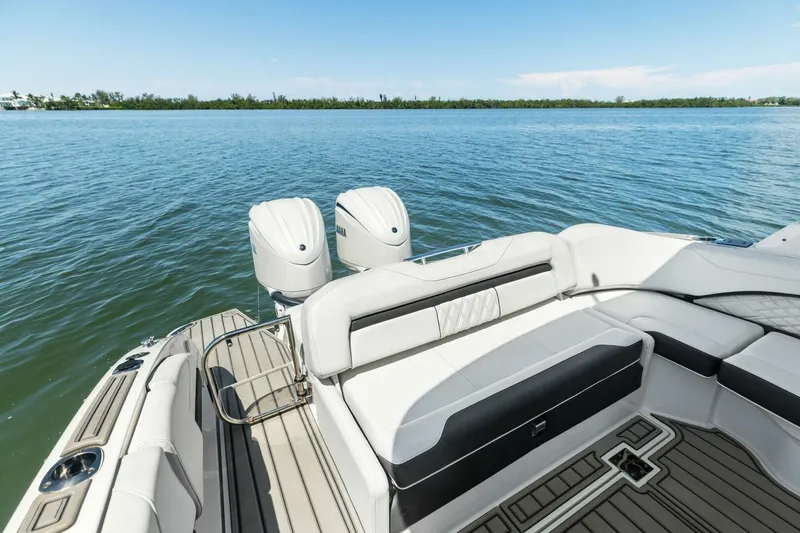  Yacht Photos Pics 2022 Regal 33 OBX boat with dual engines and luxurious seating on calm water.