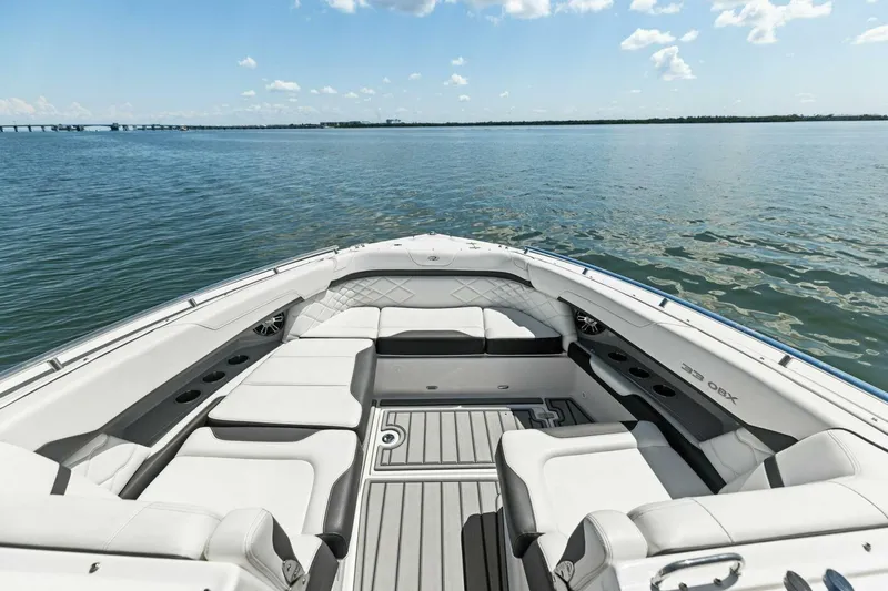  Yacht Photos Pics 2022 Regal 33 OBX boat interior with luxurious seating on calm water.