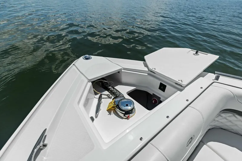  Yacht Photos Pics 2022 Regal 33 OBX boat anchor compartment with open hatch on calm water.