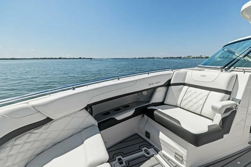 Yacht Photos Pics Luxurious 2022 Regal 33 OBX boat interior with elegant seating on a sunny day.