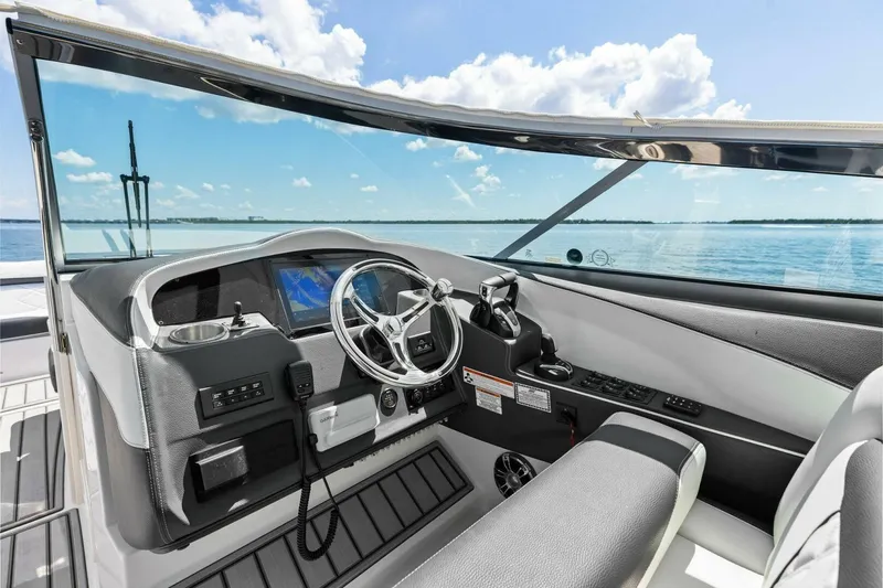  Yacht Photos Pics 2022 Regal 33 OBX boat cockpit with modern steering and navigation system.