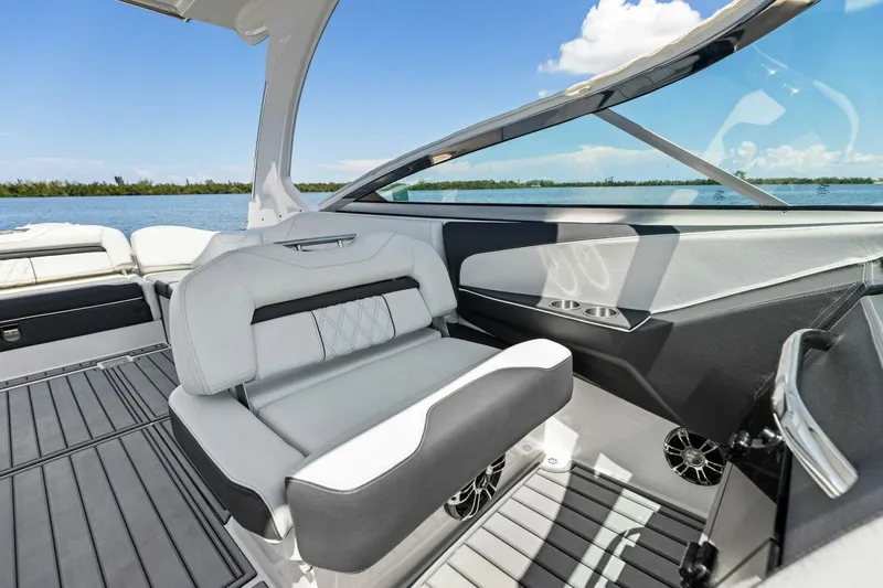  Yacht Photos Pics 2022 Regal 33 OBX boat interior with sleek seating and modern design on a sunny day.