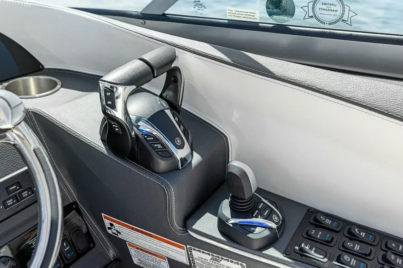  Yacht Photos Pics 2022 Regal 33 OBX boat controls with steering wheel and throttle levers.