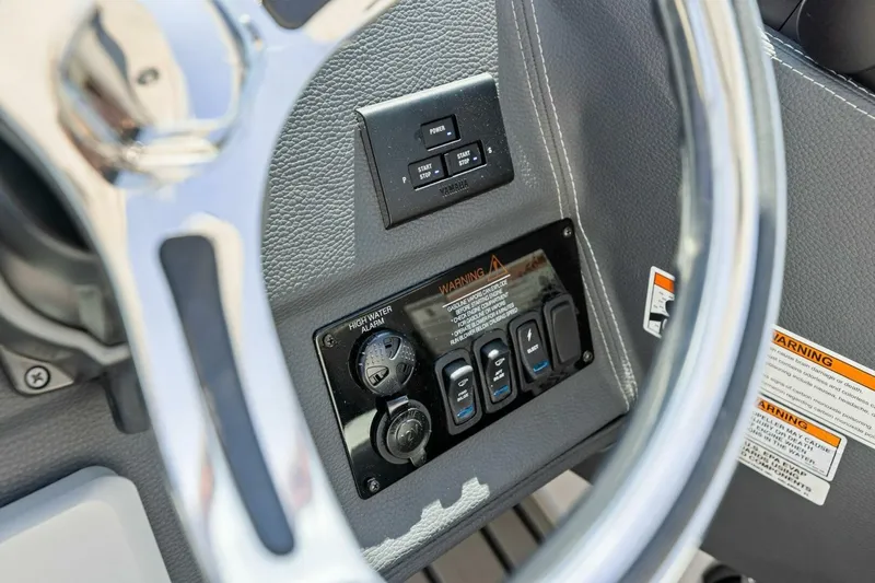  Yacht Photos Pics 2022 Regal 33 OBX boat dashboard with steering wheel and control switches.