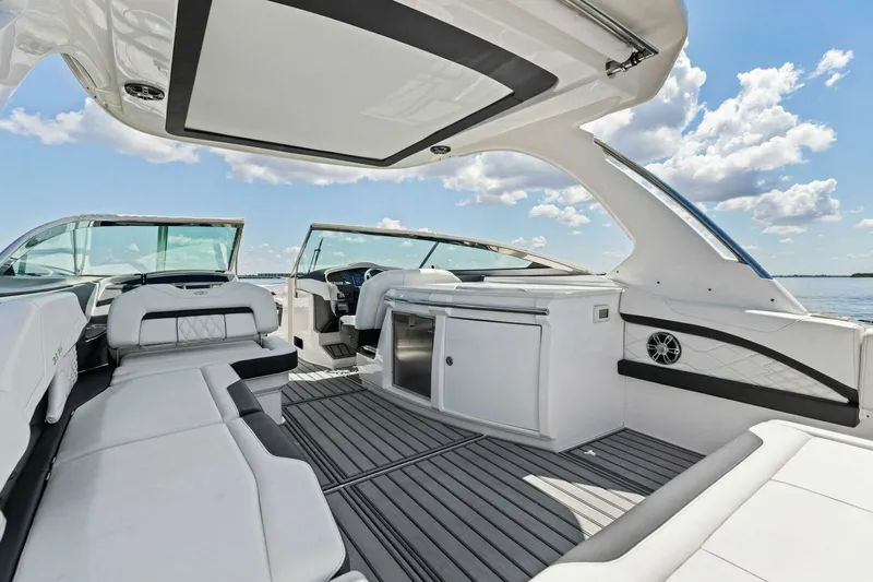  Yacht Photos Pics 2022 Regal 33 OBX boat interior with luxurious seating and modern design on a sunny day.