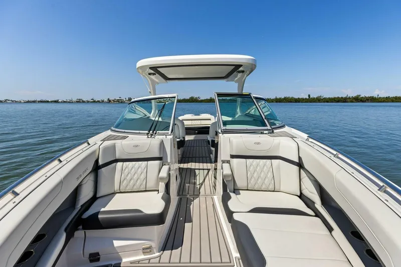  Yacht Photos Pics 2022 Regal 33 OBX boat interior with luxurious seating on calm water.