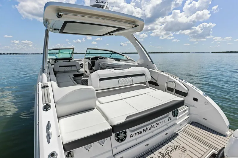  Yacht Photos Pics 2022 Regal 33 OBX boat with luxurious seating on calm waters.