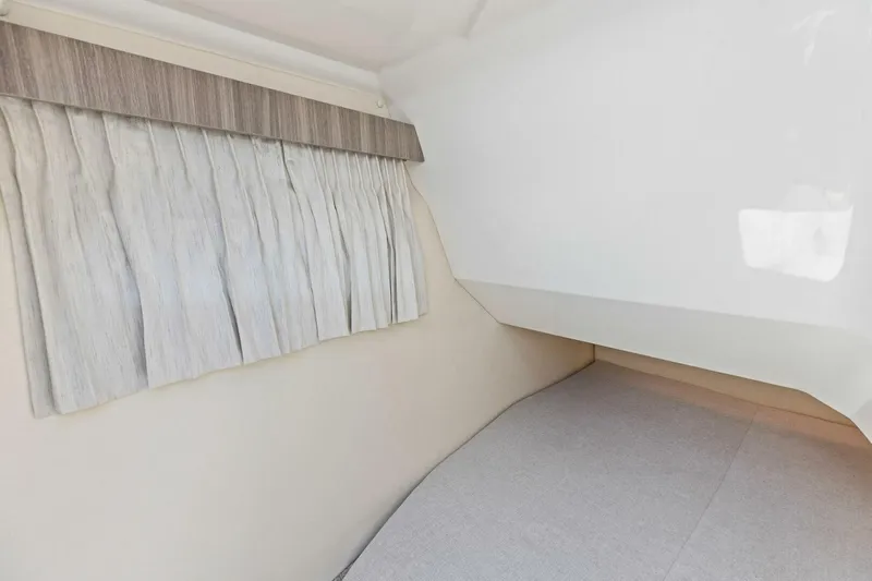  Yacht Photos Pics 2022 Regal 33 OBX interior cabin with curtain and bed.