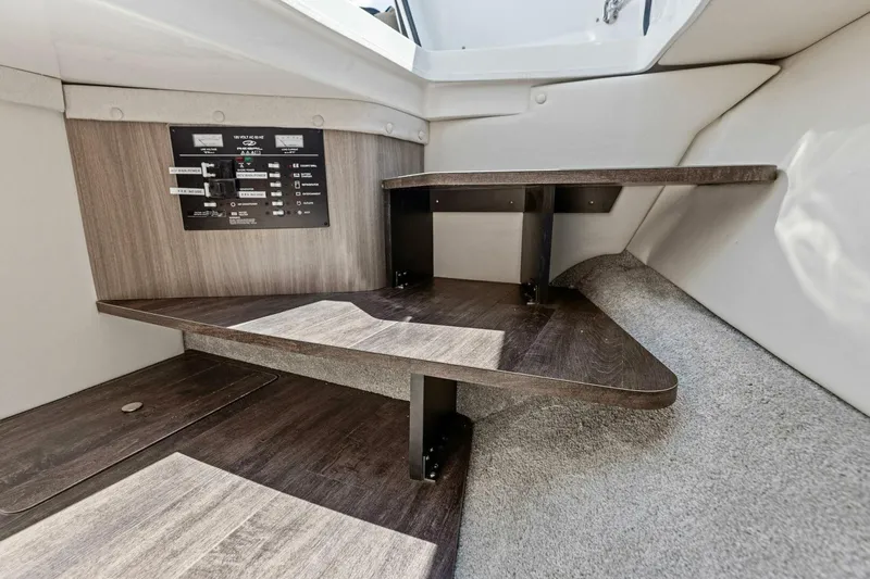  Yacht Photos Pics 2022 Regal 33 OBX interior with wooden steps and control panel.