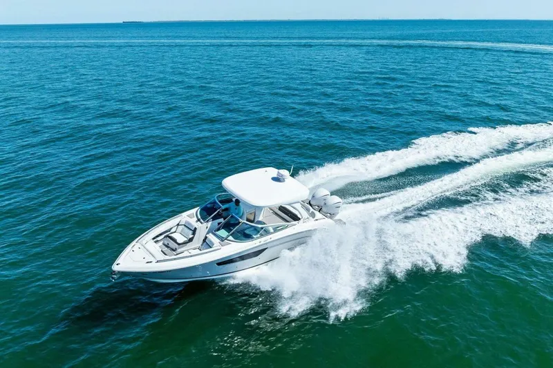  Yacht Photos Pics 2022 Regal 33 OBX boat cruising on open blue water.