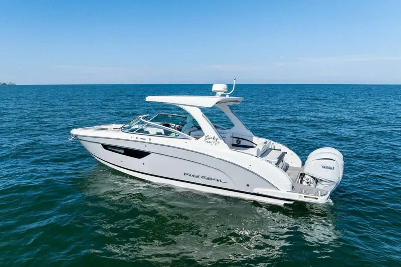  Yacht Photos Pics 2022 Regal 33 OBX boat cruising on open water with Yamaha engines.