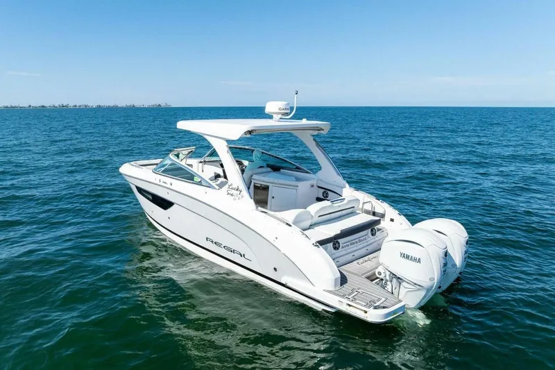  Yacht Photos Pics 2022 Regal 33 OBX boat cruising on open water with Yamaha engines.