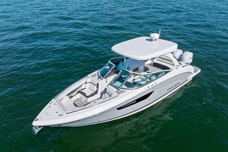  Yacht Photos Pics 2022 Regal 33 OBX boat cruising on open water, showcasing sleek design and luxury features.