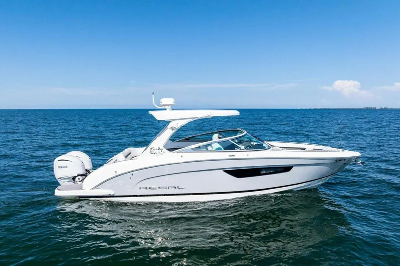  Yacht Photos Pics 2022 Regal 33 OBX boat cruising on open water under clear blue sky.